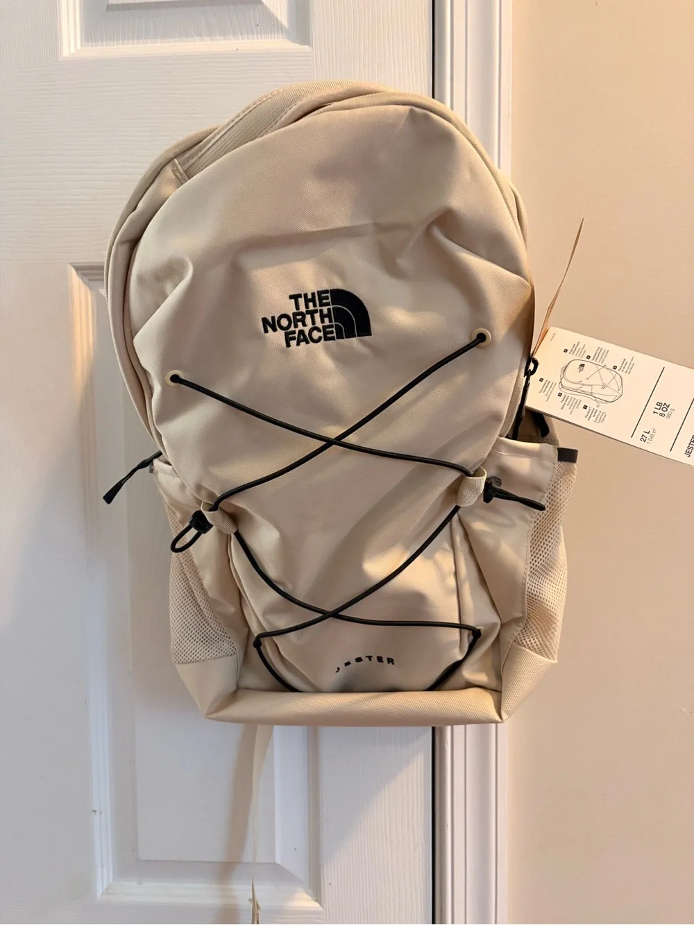 The North Face Cream Backpack with Black Bungee Cord